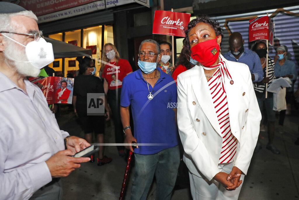 Kathy Willens Rep. Yvette Clarke, right, D-N.Y., chats with a supporter from her district outside Clarke's campaign headquarters Tuesday, June 23, 2020, in the Brooklyn borough of New York. Clarke is facing a challenge in the primary from the left wing of the party. (AP Photo/Kathy Willens)
