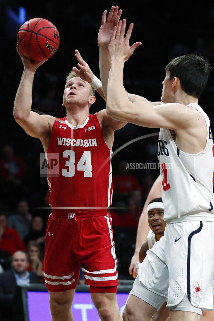 Kathy Willens Wisconsin guard Brad Davison (34) takes a shot with Richmond guard Andre Gustavson (22) defending during the first half of an NCAA college basketball game in the Legends Classic, Monday, Nov. 25, 2019, in New York. (AP Photo/Kathy Willens)