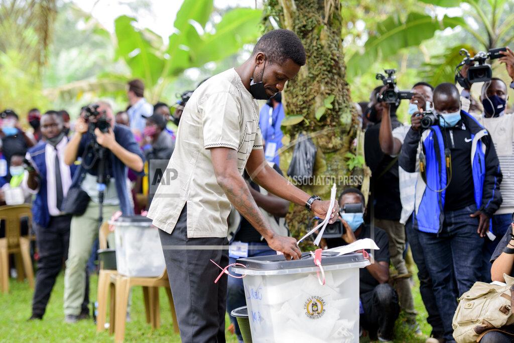 Nicholas Bamulanzeki Uganda's leading opposition challenger Bobi Wine casts his vote in Kampala, Uganda, Thursday, Jan. 14, 2021. Ugandans are voting in a presidential election tainted by widespread violence that some fear could escalate as security forces try to stop supporters of Wine from monitoring polling stations.(AP Photo/Nicholas Bamulanzeki)