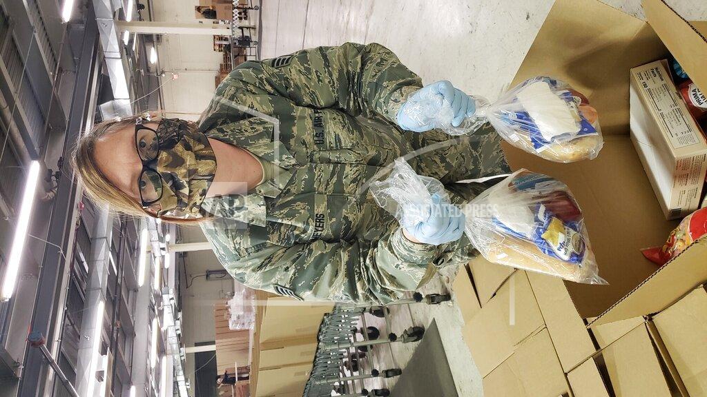 Uncredited In a photo provided by Project Isaiah, a member of the Michigan National Guard helps to sort food for distribution in Detroit on Friday, May 1, 2020 as part of the Project Isaiah relief effort bringing thousands of prepackaged meals to COVID-positive residents in the city. (Project Isaiah via AP)