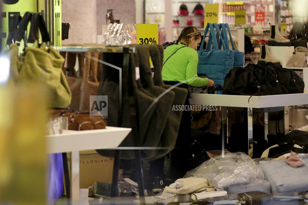 Matt Dunham A worker is seen through the front window inside the temporarily closed Topshop flagship store on Oxford Street, during England's second coronavirus lockdown, in London, Monday, Nov. 30, 2020. Arcadia Group, the retail empire of tycoon Philip Green, which owns well-known British fashion chains like Topshop and employs around 15,000 people, appears to be on the brink of collapse following the economic shock of the coronavirus pandemic. (AP Photo/Matt Dunham)