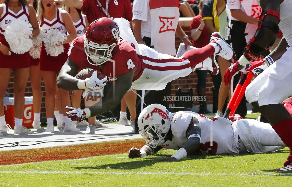 Sue Ogrocki FILE - In this Saturday, Sept. 1, 2018 file photo, Oklahoma running back Trey Sermon (4) dives over Florida Atlantic safety James Pierre (23) for a touchdown in the first half of an NCAA college football game in Norman, Okla. Oklahoma lost star Rodney Anderson for the season to a right knee injury against UCLA over the weekend. Sermon is one of the top backs left in the rotation. (AP Photo/Sue Ogrocki, File)