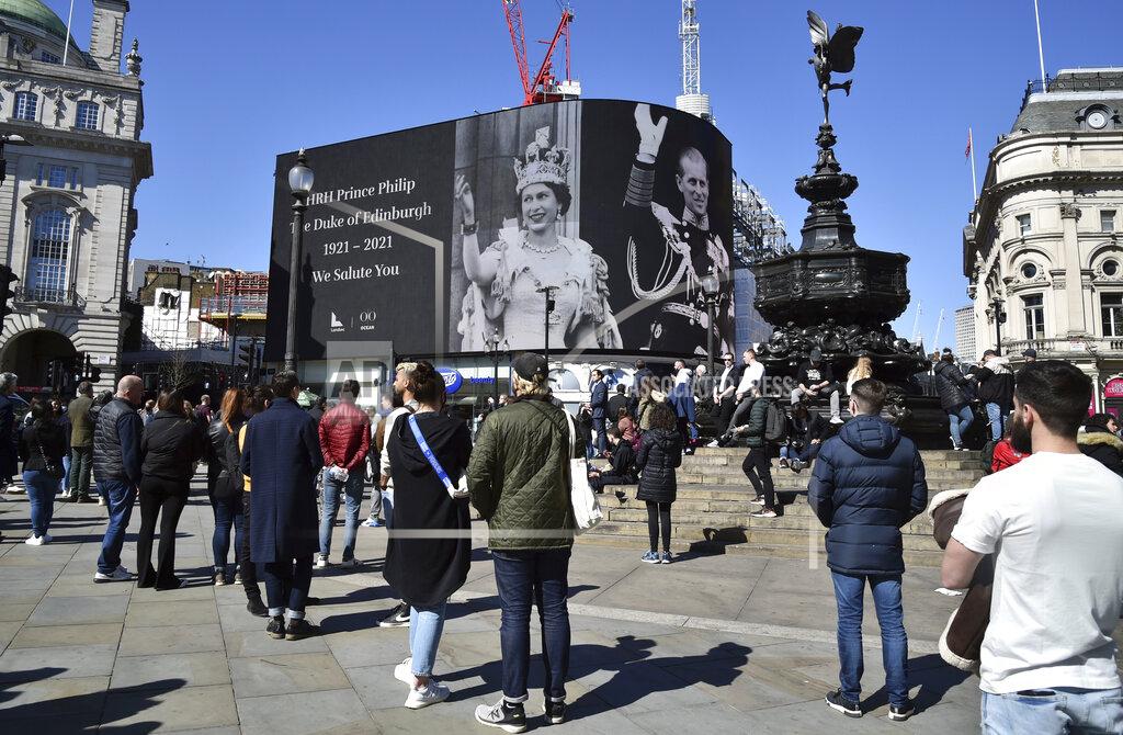 Rui Vieira People observe a minute's silence for Britain's Prince Philip at Piccadilly Circus in London Saturday, April 17, 2021. Prince Philip, husband of Queen Elizabeth II, died Friday April 9 aged 99. His funeral service is taking place at St. George's Chapel inside Windsor Castle Saturday. (AP Photo/Rui Vieira)
