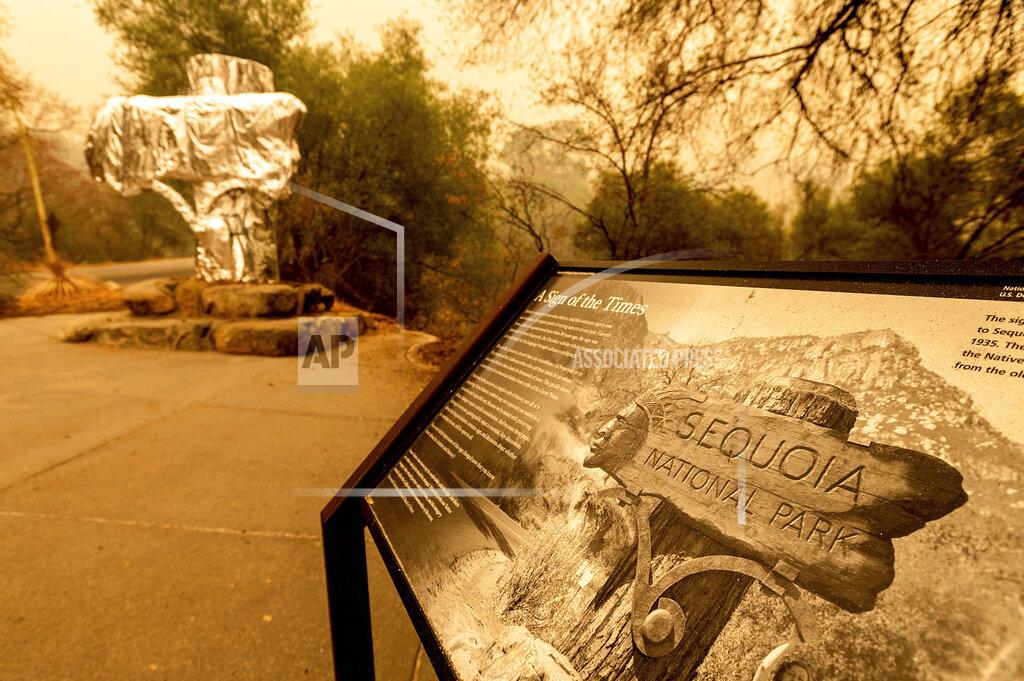 Noah Berger FILE - In this Wednesday, Sept. 15, 2021, file photo, fire-resistant wrap covers an historic welcome sign as the KNP Complex Fire burns in Sequoia National Park, Calif. More than 2,000 firefighters are on the lines Monday, Sept. 27, as the 133-square-mile Windy Fire burns on the Tule River Indian Reservation and in Sequoia National Forest. (AP Photo/Noah Berger, File)
