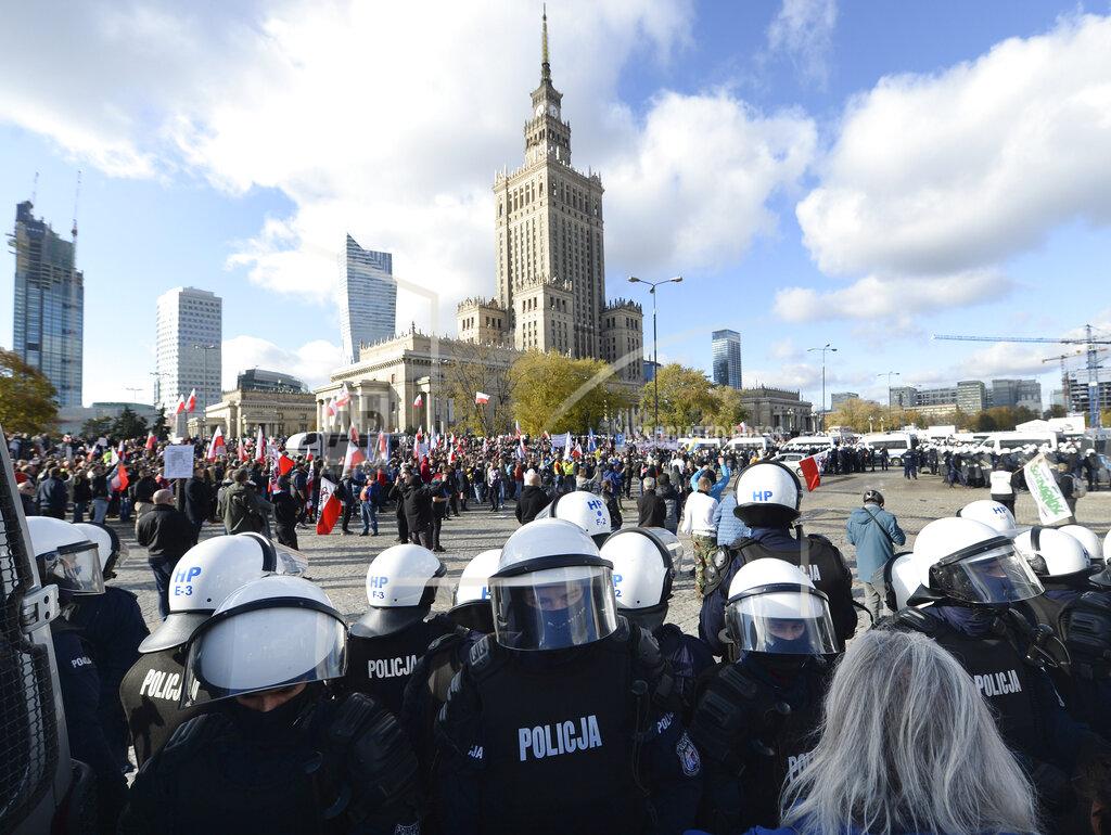 Czarek Sokolowski Polish police face protesters, angry over new restrictions aimed at fighting the coronavirus pandemic, in Warsaw, Poland, Saturday, Oct. 24, 2020. The protesters included entrepreneurs, far-right politicians, football fans and vaccine opponents. The clashes come amid rising social tensions and as new restrictions just short of a full lockdown took effect Saturday. (AP Photo/Czarek Sokolowski)