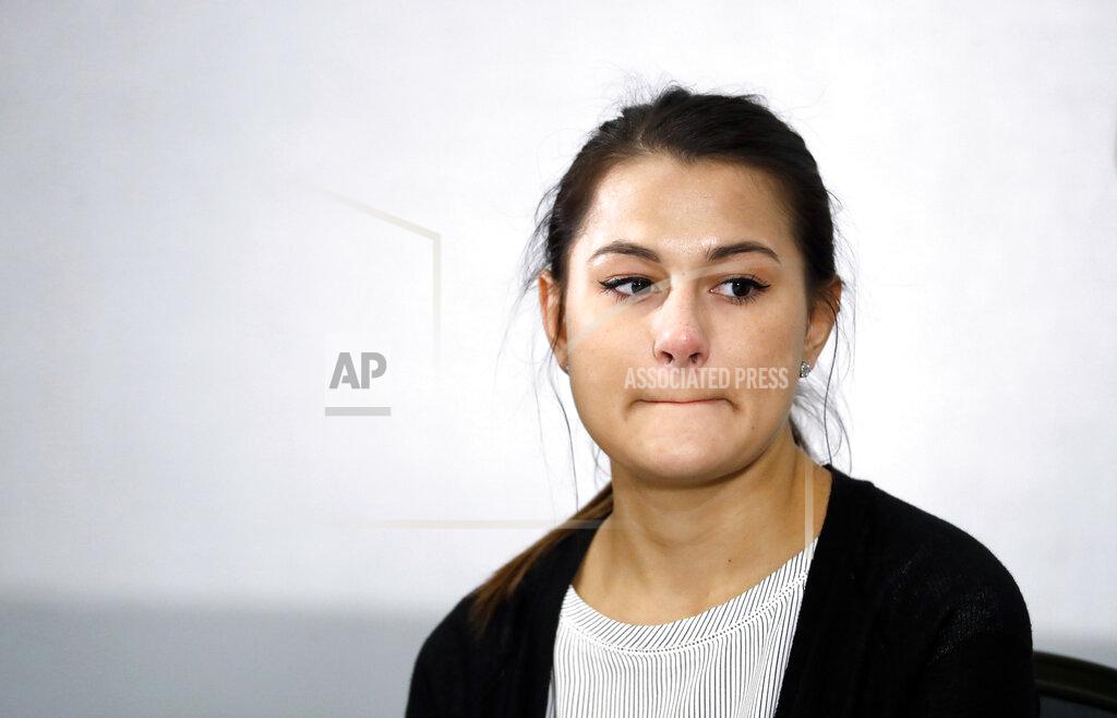 Paul Sancya Bailey Kowalski appears during a news conference in East Lansing, Mich., Thursday, April 11, 2019. The 22-year-old Michigan State University student is speaking publicly a year after suing the school, alleging that three former men's basketball players raped her in 2015 and that she was discouraged by counseling center staff from reporting what happened.