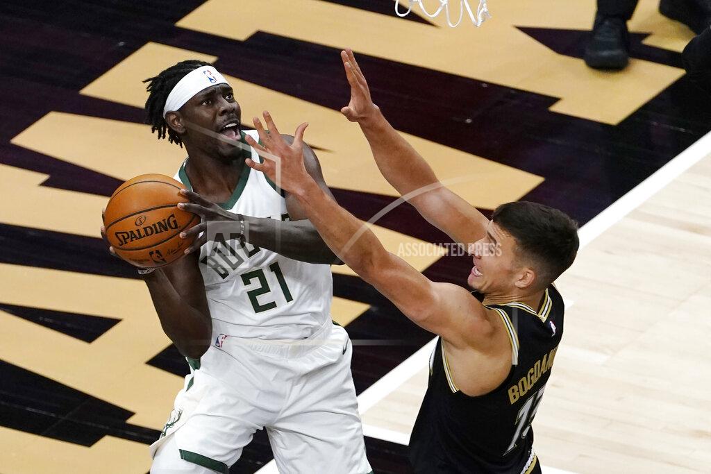 John Bazemore Milwaukee Bucks guard Jrue Holiday (21) tries to pass as Atlanta Hawks guard Bogdan Bogdanovic (13) defends during the first half of an NBA basketball game Thursday, April 15, 2021, in Atlanta. (AP Photo/John Bazemore)