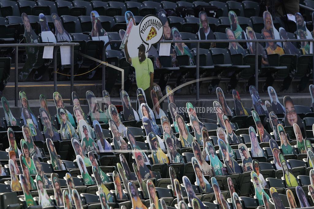 Jeff Chiu Cardboard cutouts of a vendor, fans and former Oakland Athletics players are placed in seats at Oakland Coliseum before a baseball game between the Athletics and the Los Angeles Angels in Oakland, Calif., Friday, July 24, 2020. (AP Photo/Jeff Chiu)
