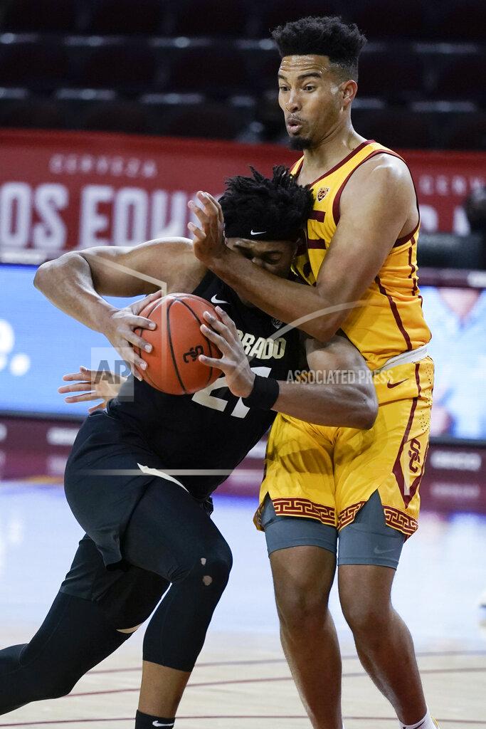 Jae C. Hong Colorado's Evan Battey, left, is defended closely by Southern California's Isaiah Mobley during the first half of an NCAA college basketball game Thursday, Dec. 31, 2020, in Los Angeles. (AP Photo/Jae C. Hong)