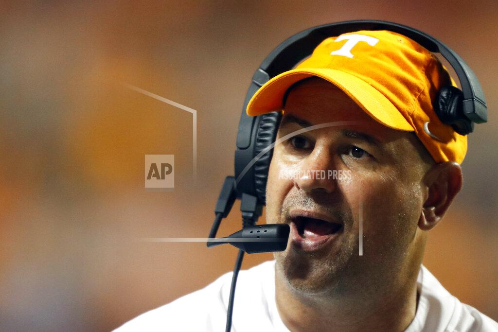 Wade Payne FILE - In this Oct. 5 2019, file photo, Tennessee head coach Jeremy Pruitt talks to a player in the second half of an NCAA college football game against Georgia in Knoxville, Tenn. The coronavirus is preventing prospects from leaving home to visit campuses and is keeping college coaches from traveling to evaluate players across the country. (AP Photo/Wade Payne, File)