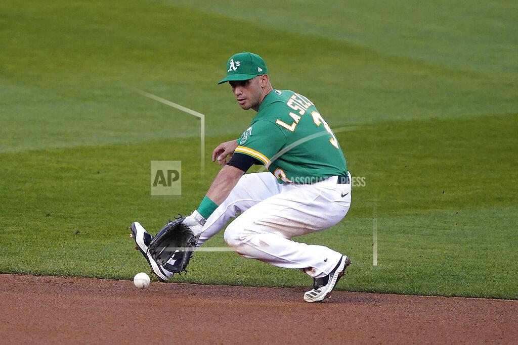 Tony Avelar Oakland Athletics second baseman Tommy La Stella backhands a ground ball that was hit by San Diego Padres' Jake Cronenworth during the second inning of a baseball game in Oakland, Calif., Friday, Sept. 4, 2020. Cronenworth was out at first. (AP Photo/Tony Avelar)