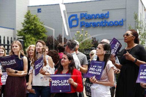 FILE - In this June 4, 2019, file photo, anti-abortion advocates gather outside the Planned Parenthood clinic in St. Louis. A federal appeals court on Tuesday, Sept. 21, 2021, will consider whether Missouri can implement a sweeping law aimed at limiting abortions. The law adopted in 2019 would ban abortions at or around the eighth week of pregnancy. It also would prohibit abortions based on a Down syndrome diagnosis. (AP Photo/Jeff Roberson, File)