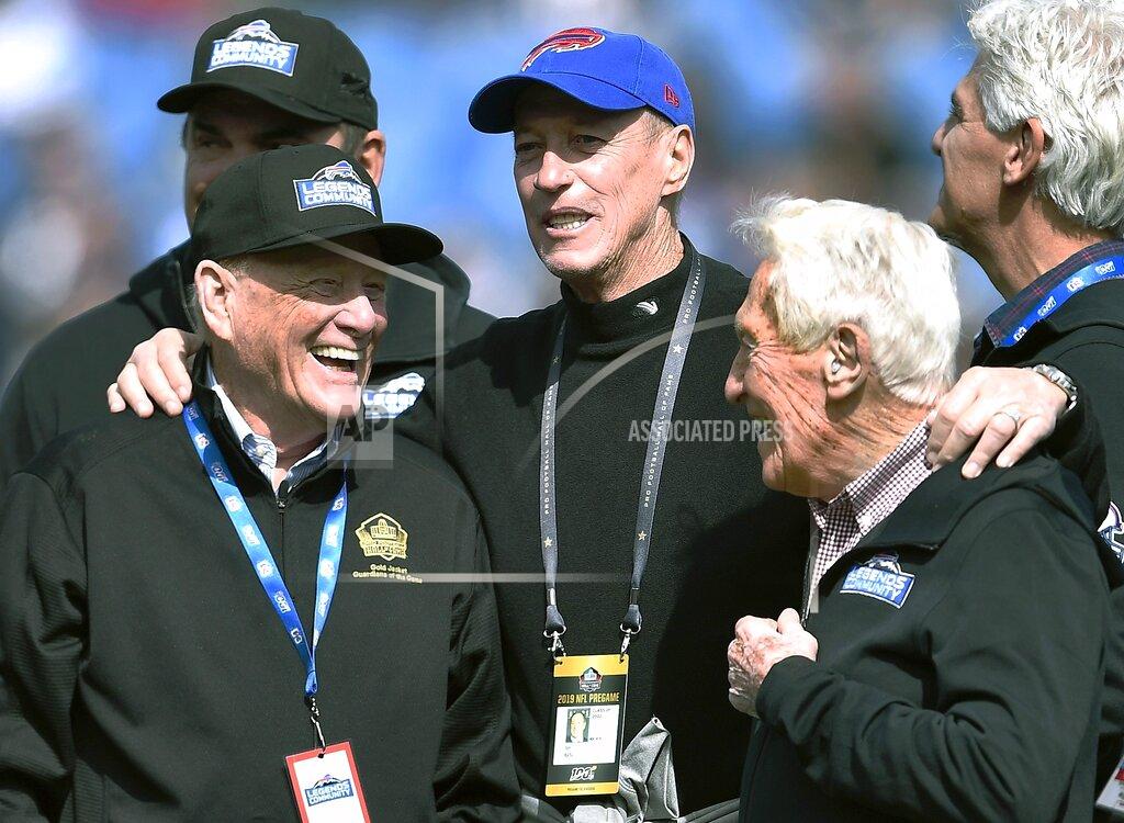 Adrian Kraus Former Buffalo Bills general manager Bill Polian, left, former quarterback Jim Kelly, center, and former head coach Marv Levy stand on the field together before an NFL football game between the Bills and the New England Patriots, Sunday, Sept. 29, 2019, in Orchard Park, N.Y. (AP Photo/Adrian Kraus)
