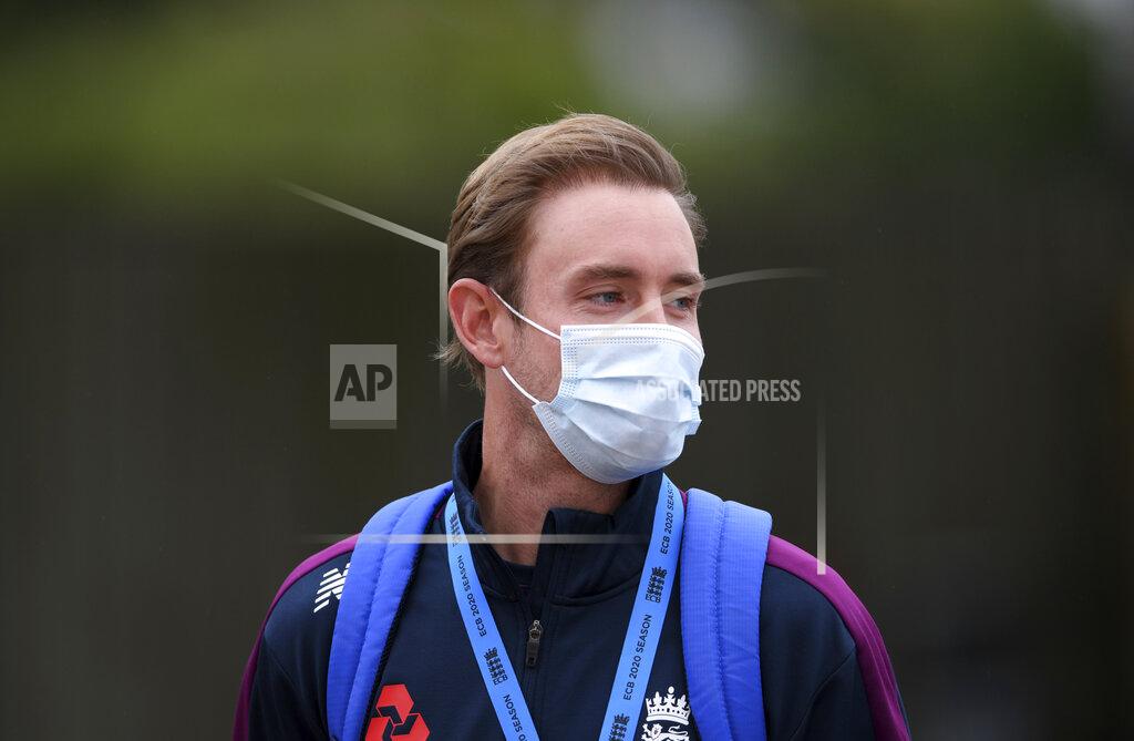 Mike Hewitt England's Stuart Broad wears a face mask as a precaution against the coronavirus as he watches teammates train before the start of the first day of the 1st cricket Test match between England and West Indies, at the Ageas Bowl in Southampton, England, Wednesday July 8, 2020. (Mike Hewitt/Pool via AP)