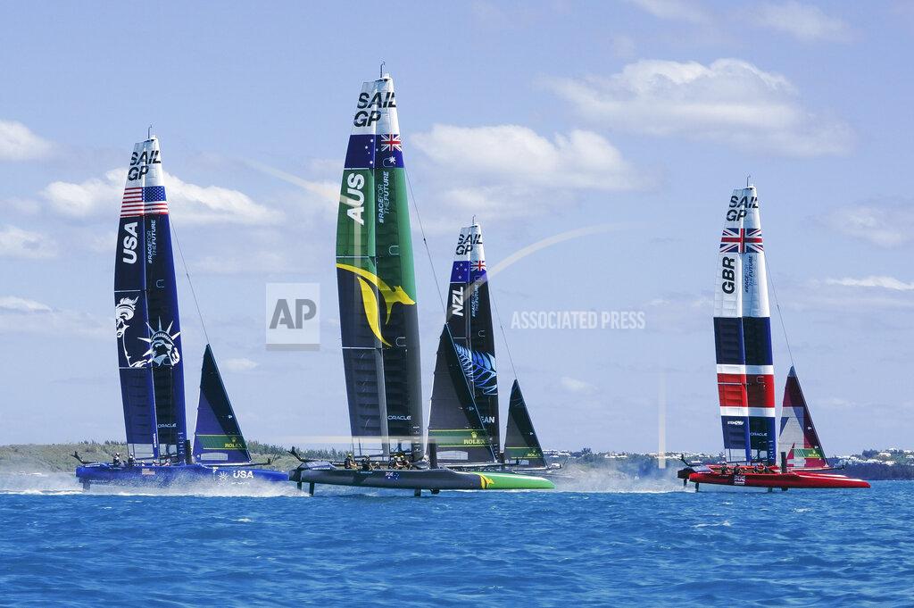 Thomas Lovelock In this photo provided by SailGP, from left to right, the USA, Australia, New Zealand and Britain SailGP teams compete during the Bermuda SailGP in Hamilton, Bermuda, on Friday, April 23, 2021. Skipper Tom Slingsby and defending champion Team Australia won all three fleet races Friday on Bermuda's Great Sound in an impressive performance on the first day of the second season of the SailGP global league. (Thomas Lovelock/SailGP via AP)