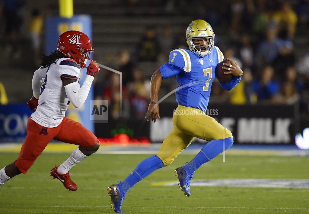 Mark J. Terrill UCLA quarterback Dorian Thompson-Robinson, right, runs the ball as Arizona safety Jarrius Wallace gives chase during the first half of an NCAA college football game, Saturday, Oct. 20, 2018, in Pasadena, Calif. (AP Photo/Mark J. Terrill)