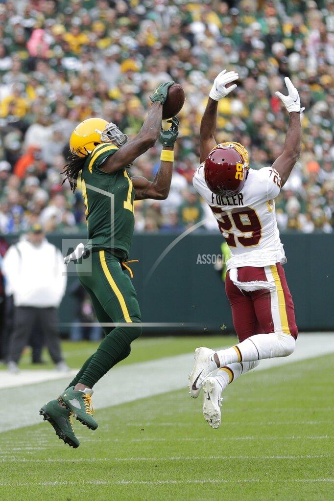 Aaron Gash Green Bay Packers' Davante Adams catches a pass in front of Washington Football Team's Kendall Fuller during the second half of an NFL football game Sunday, Oct. 24, 2021, in Green Bay, Wis. (AP Photo/Aaron Gash)