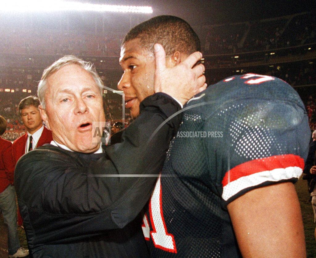 Denis Poroy FILE - In this Dec. 30, 1998, file photo, Arizona coach Dick Tomey, left, congratulates linebacker DaShon Polk after the Wildcats 23-20 win over Nebraska in the Holiday Bowl NCAA college football game in San Diego. Tomey, the winningest football coach in University of Arizona history, died Friday night, May 10, 2019, in Tucson, Ariz. He was 80. Tomey was 183-145-7 overall in 20 years as head coach at Hawaii, Arizona and San Jose State. He was diagnosed with lung cancer in December. (AP Photo/Denis Poroy, File)