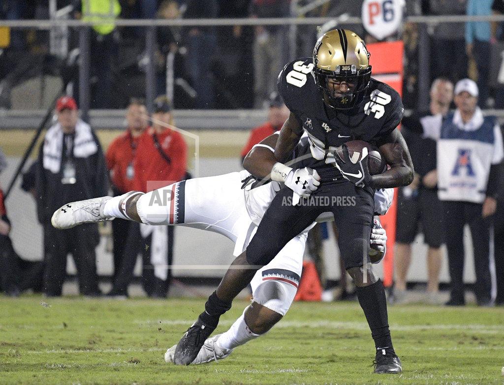 Phelan M. Ebenhack Central Florida running back Greg McCrae (30) rushes for a 9-yard touchdown in front of Cincinnati defensive end Malik Vann during the second half of an NCAA college football game Saturday, Nov. 17, 2018, in Orlando, Fla. Central Florida won, 38-13. (AP Photo/Phelan M. Ebenhack)