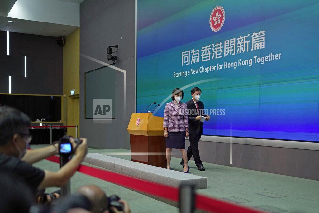 Kin Cheung Hong Kong Chief Executive John Lee, right, and convener of the Executive Council Regina Ip leave a news conference in Hong Kong, Tuesday, July 5, 2022. Lee said Tuesday in his first news conference since taking the reins that he will work towards legislating easing restrictions for travelers, but that it must be balanced with limiting the spread of the coronavirus so as not to overwhelm the healthcare system. (AP Photo/Kin Cheung)