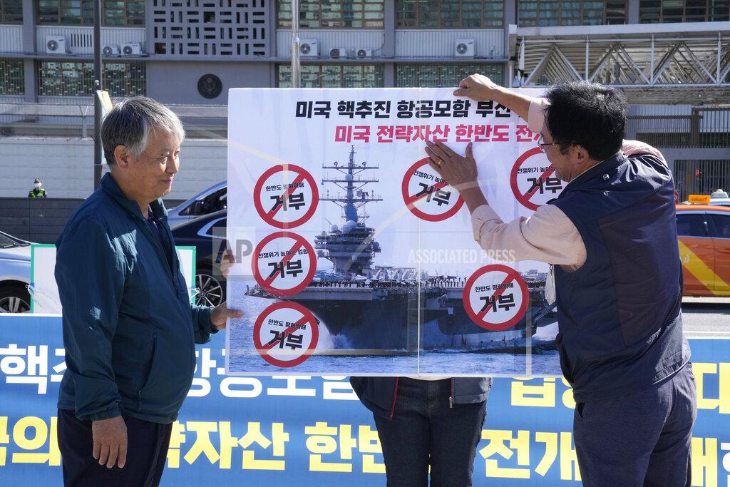 Ahn Young-Joon Protesters put stickers on a banner during a rally to oppose the planned the joint military exercises between the U.S. and South Korea in front of the U.S. Embassy in Seoul, South Korea, Thursday, Sept. 22, 2022. The nuclear-powered aircraft carrier USS Ronald Reagan arrived in the South Korean port of Busan on Friday ahead of the two countries' joint military exercise that aims to show their strength against growing North Korean threats. The signs read: "Refusal for peace on the Korean Peninsula." (AP Photo/Ahn Young-joon)