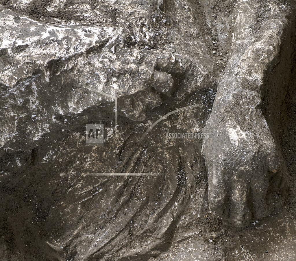 Uncredited A detail of the casts of one of two bodies that are believed to have been a rich man and his male slave fleeing the volcanic eruption of Vesuvius nearly 2,000 years ago, are seen in what was an elegant villa on the outskirts of the ancient Roman city of Pompeii destroyed by the eruption in 79 A.D., where they were discovered during recents excavations, Pompeii archaeological park officials said Saturday, Nov. 21, 2020. (Parco Archeologico di Pompei via AP)