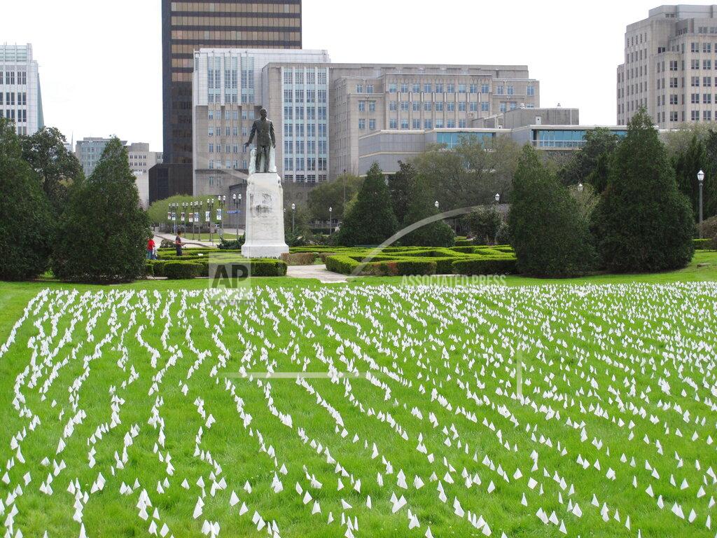 Melinda Deslatte White flags, placed by Gov. John Bel Edwards' office and representing every Louisiana death from COVID-19, are displayed outside the state Capitol, Tuesday, March 9, 2021, are near the statue of former Gov. Huey Long in Baton Rouge, La. (AP Photo/Melinda Deslatte) Slug BC-LA--Virus Outbreak-Louisiana Gov. John Bel Edwards' office placed