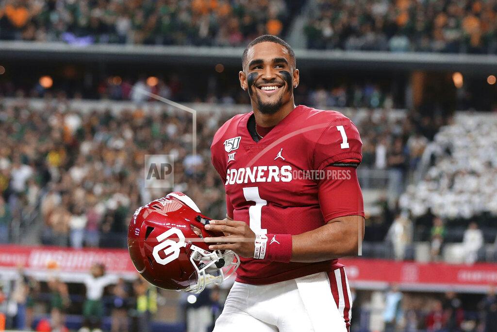 Rod Aydelotte FILE - In this Dec. 9, 2019, file photo, Oklahoma quarterback Jalen Hurts smiles on the sidelines before an NCAA college football game against Baylor for the Big-12 championship, in Arlington, Texas. Hurts, the Heisman Trophy runner-up who once starred for Alabama, is hoping to improve his NFL draft stock at the Senior Bowl. (Rod Aydelotte/Waco Tribune Herald, via AP, File)