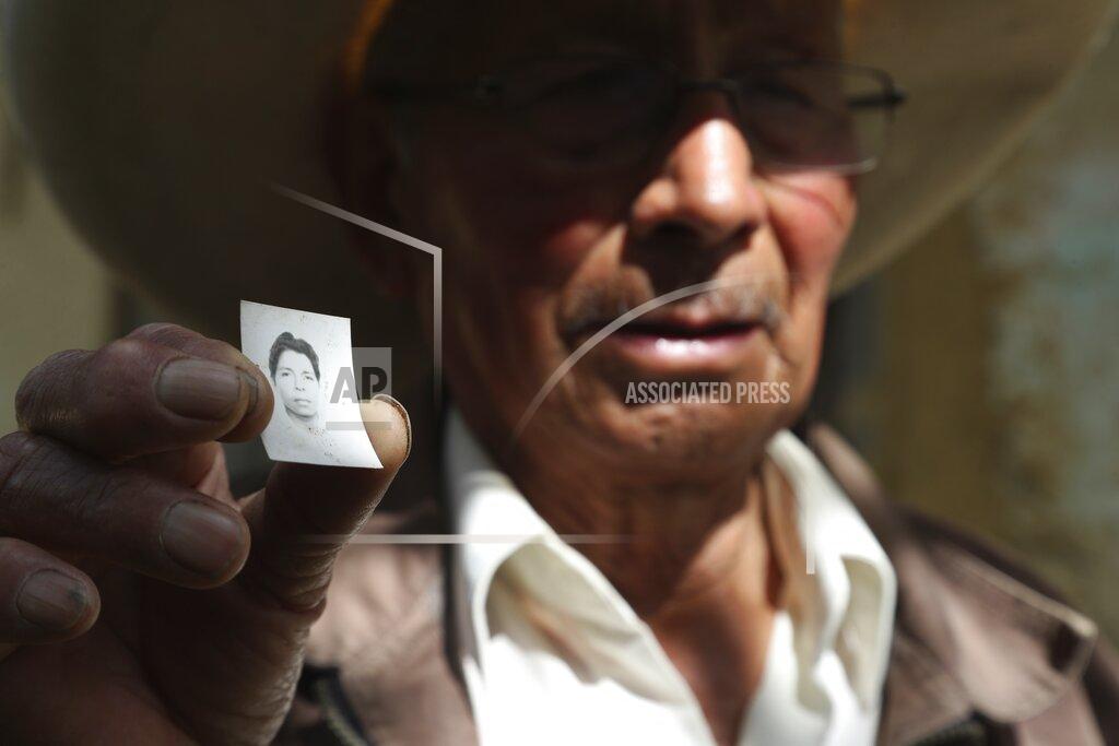 Martin Mejia Ireño Castillo, the father of Free Peru party presidential candidate Pedro Castillo, shows an old photo of his son in Puna, Peru, Friday, April 16, 2021. Castillo's son, who has proposed rewriting Peru's constitution and deporting all immigrants living in the country illegally who commit crimes, will face rival candidate Keiko Fujimori in the June 6 presidential run-off election. (AP Photo/Martin Mejia)