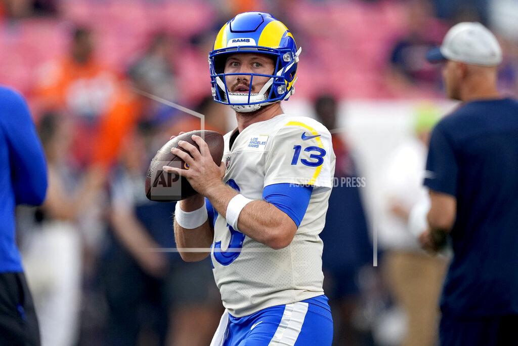 Los Angeles Rams quarterback John Wolford (13) warms up prior to an NFL preseason football game against the Denver Broncos, Saturday, Aug. 28, 2021, in Denver. (AP Photo/David Zalubowski)