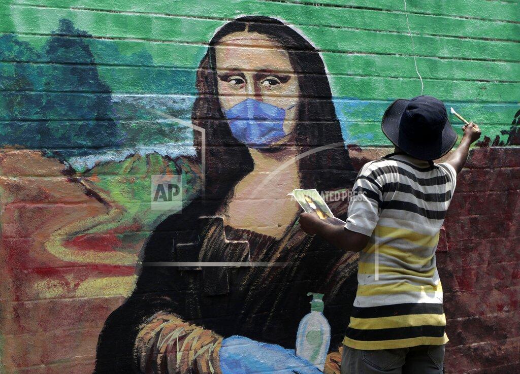 Rajanish Kakade An artist makes a mural of the Monalisa wearing a face mask to spread awareness for the prevention of the coronavirus in Mumbai, India, Wednesday, March 24, 2021. (AP Photo/Rajanish Kakade)