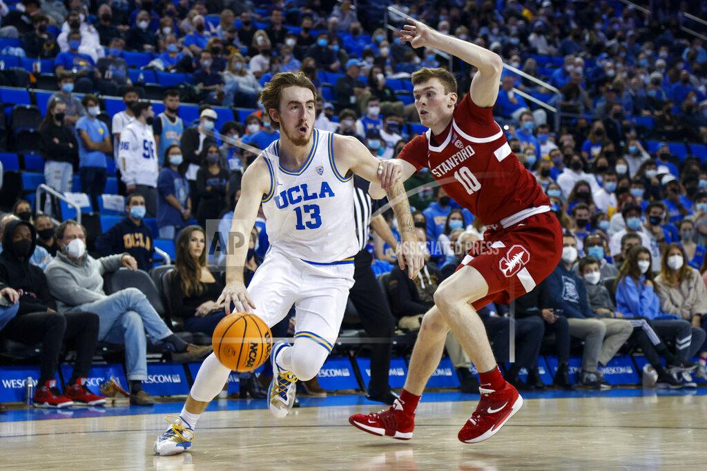 Ringo H.w. Chiu UCLA guard Jake Kyman (13) drives past Stanford forawrd Max Murrell (10) in the second half of an NCAA college basketball game Saturday, Jan. 29, 2022, in Los Angeles. (AP Photo/Ringo H.W. Chiu)