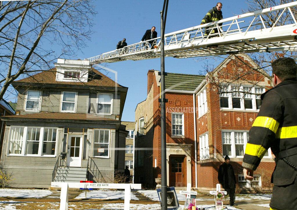 Nam Y. Huh FILE - In this March 11, 2005, file photo, Chicago police and fire officials search the roof of U.S. District Judge Joan Lefkow's Chicago home. One day after DNA evidence linked a Chicago electrician to the shooting deaths of the judges husband and mother, investigators returned to the house hoping to find the murder weapon and wrap up loose ends. Lefkow was forced to relive her family tragedy in July 2020, when a struggling lawyer armed with a gun and a grudge opened fire at the home of another female judge. (AP Photo/Nam Y. Huh, File)