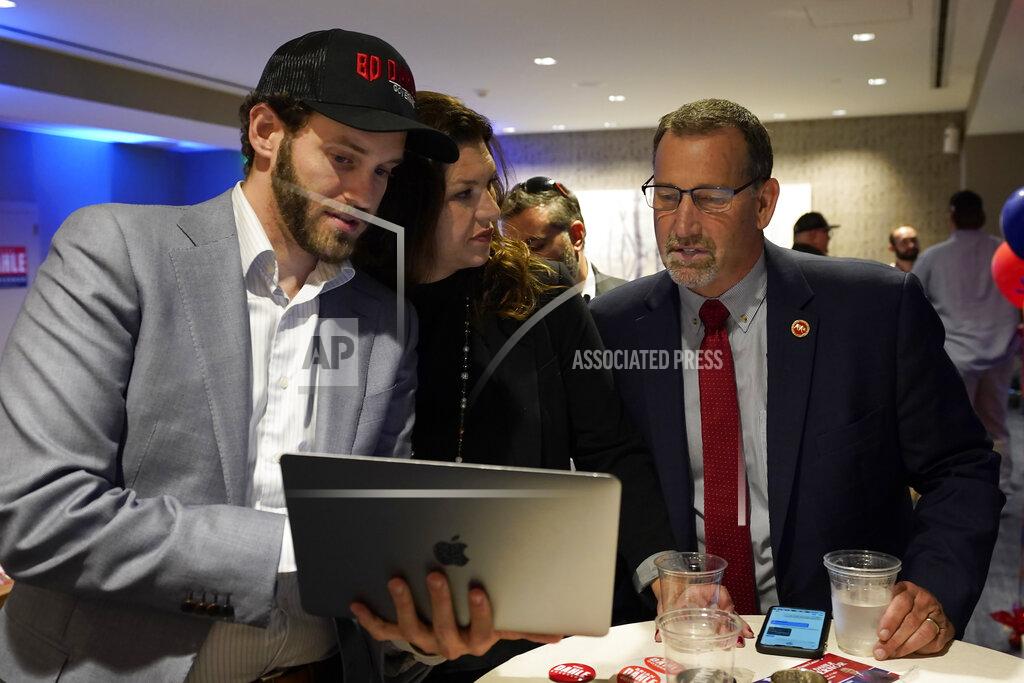 Rich Pedroncelli FILE - Republican gubernatorial candidate, state Sen. Brian Dahle, right, looks at early election returns with his wife, Assemblywoman Megan Dahle, center, on a laptop held by Erik Brahms, left, Megan Dahle's Assembly chief of staff, at an election night gathering in Sacramento, Calif., June 7, 2022. Dahle finished second in California's primary on June 7, and knows it will be hard to defeat incumbent Democratic Gov. Gavin Newsom. He plans to focus on what he says are the problems people care about the most, including high gas prices and rising crime. (AP Photo/Rich Pedroncelli, File)