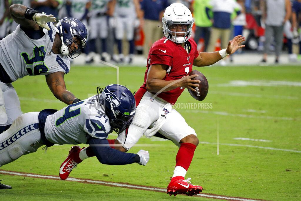 Ross D. Franklin Arizona Cardinals quarterback Kyler Murray (1) is tackled by Seattle Seahawks defensive end Ezekiel Ansah (94) as defensive tackle Quinton Jefferson (99) pursues during the second half of an NFL football game, Sunday, Sept. 29, 2019, in Glendale, Ariz. (AP Photo/Ross D. Franklin)