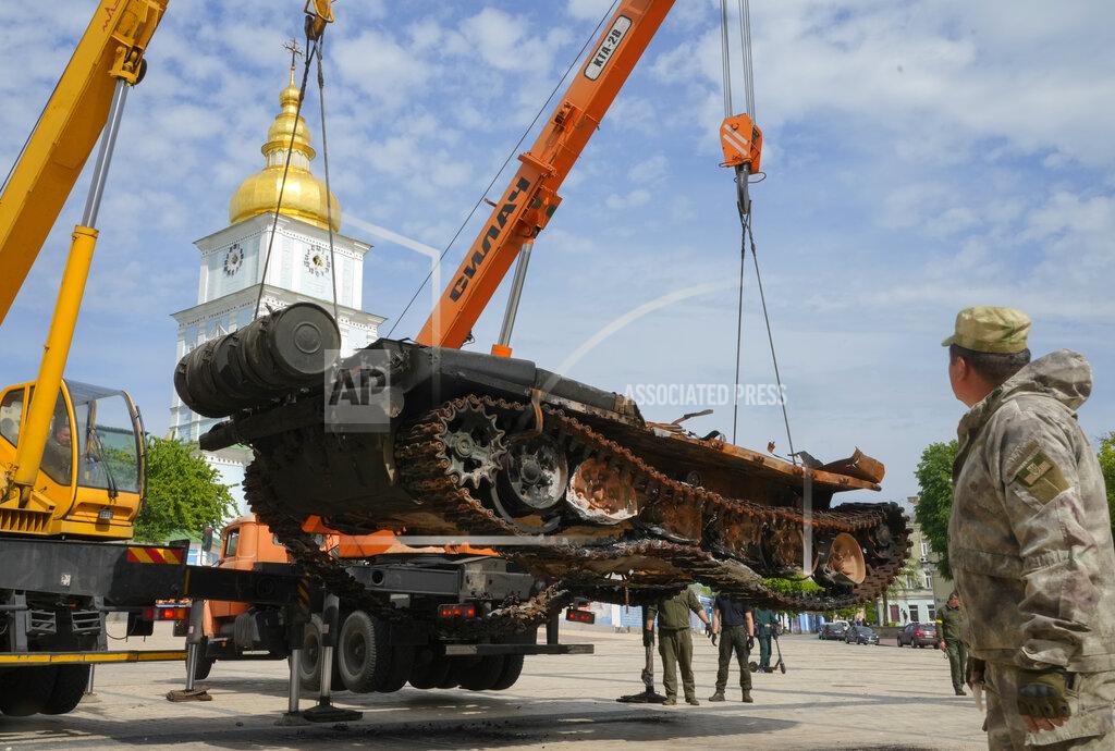 Efrem Lukatsky Ukrainian soldiers unload a destroyed Russian tank to install it as a symbol of war in central Kyiv, Ukraine, Friday, May 20, 2022. St Michael cathedral is in the background.(AP Photo/Efrem Lukatsky)