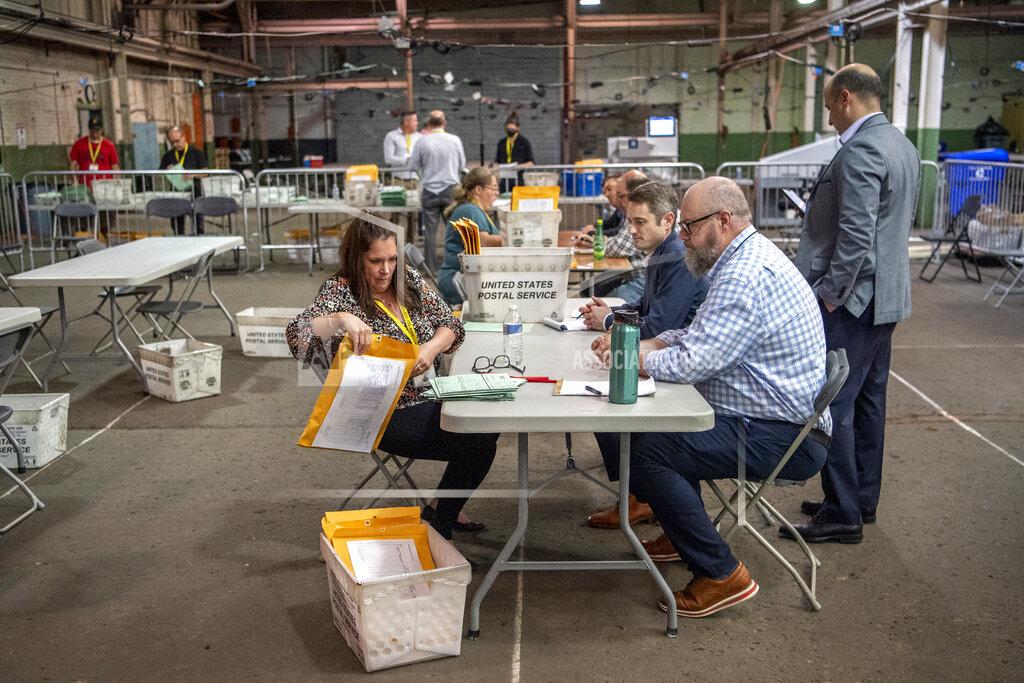 Alexandra Wimley Allegheny County elections workers review provisional ballots with authorized representatives from Dave McCormick and Dr. Mehmet Oz's campaigns, Monday, May 23, 2022, on the North Side neighborhood of Pittsburgh, Pa. (Alexandra Wimley/Pittsburgh Post-Gazette via AP)