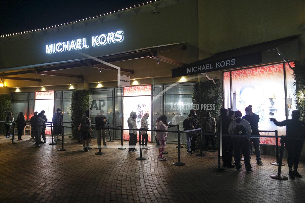 Ringo H.w. Chiu Black Friday shoppers wait in line to enter an shore that opened at 6am at the Citadel Outlets in Commerce, Calif., Friday, Nov. 27, 2020. (AP Photo/Ringo H.W. Chiu)