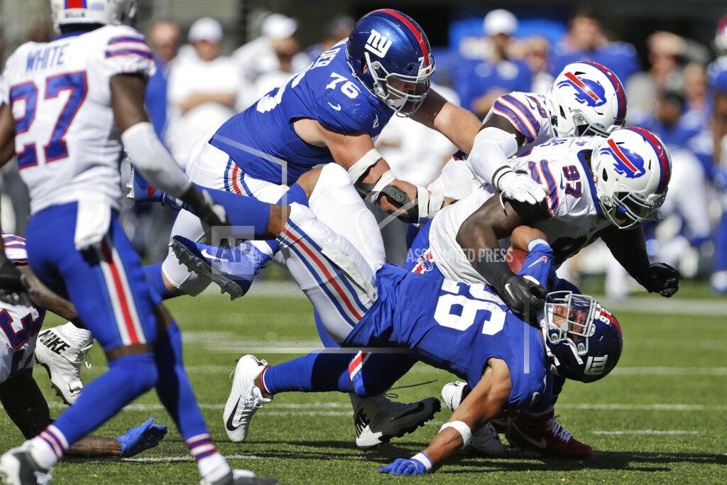 Adam Hunger Buffalo Bills defense tackles New York Giants' Saquon Barkley, bottom, during the second half of an NFL football game, Sunday, Sept. 15, 2019, in East Rutherford, N.J. (AP Photo/Adam Hunger)