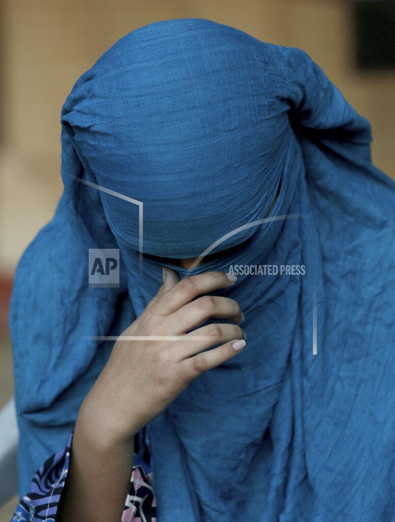 Fareed Khan Neha, 15, who was married as a child, pauses during an interview in Karachi, Pakistan, on Wednesday, Nov. 11, 2020. Neha said she was tricked into marriage by a favorite aunt. Instead of going to a hospital to visit a relative, she was taken to the home of her aunt’s in-laws and told she would marry her aunt’s 45-year-old brother-in-law. “I told her I can’t, I am too young and I don’t want to. He is old,” Neha said. “She slapped me and locked me up in a room.” (AP Photo/Fareed Khan)