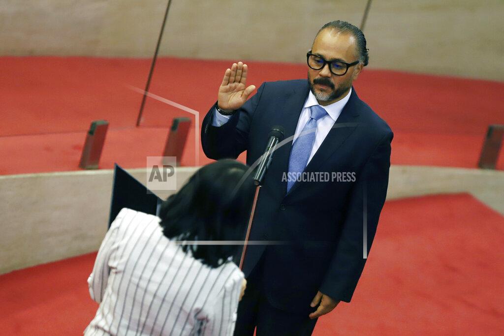 Salvador Melendez New Ideas party lawmaker Ernesto Castro is sworn-in as president of the El Salvador's Congress in San Salvador, El Salvador, Saturday, May 1, 2021. For the first time in three decades the traditional conservative and leftist parties have been sidelined by a resounding electoral defeat, clearing the way for President Nayib Bukele's party to help him advance his agenda. (AP Photo/Salvador Melendez)