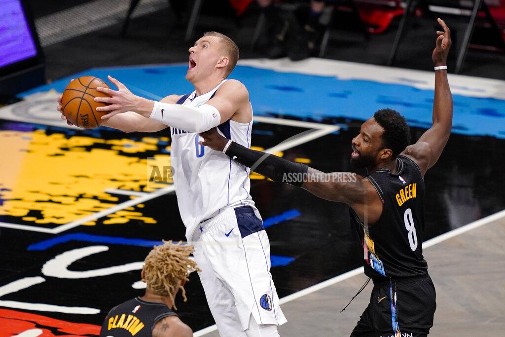 John Minchillo Dallas Mavericks center Kristaps Porzingis (6) shoots against Brooklyn Nets forward Jeff Green (8) during the second half of an NBA basketball game Saturday, Feb. 27, 2021, in New York. (AP Photo/John Minchillo)