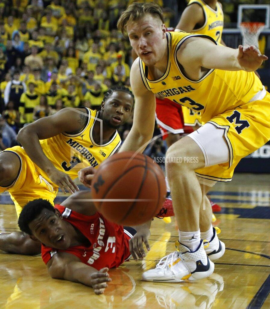 Carlos Osorio Ohio State guard C.J. Jackson (3) passes the ball as Michigan guard Zavier Simpson (3) and forward Ignas Brazdeikis (13) defend during the first half of an NCAA college basketball game Tuesday, Jan. 29, 2019, in Ann Arbor, Mich. (AP Photo/Carlos Osorio)