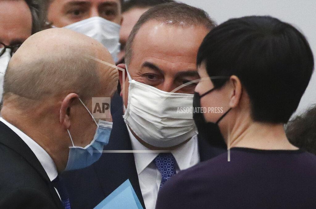 Yves Herman Turkish Foreign Minister Mevlut Cavusoglu, center, talks to Norway's Foreign Minister Ine Eriksen Soreide, right, and French Foreign Minister Jean-Yves Le Drian during a NATO foreign ministers meeting at NATO headquarters in Brussels, Tuesday, March 23, 2021. (Yves Herman, Pool via AP)