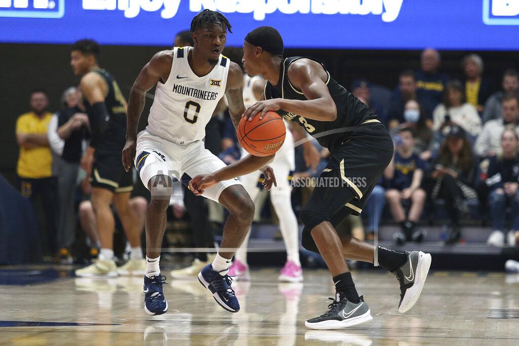 Kathleen Batten Oakland forward Micah Parrish (3) is defended by West Virginia guard Kedrian Johnson (0) during the second half of an NCAA college basketball game in Morgantown, W.Va., Tuesday, Nov. 9, 2021. (AP Photo/Kathleen Batten)