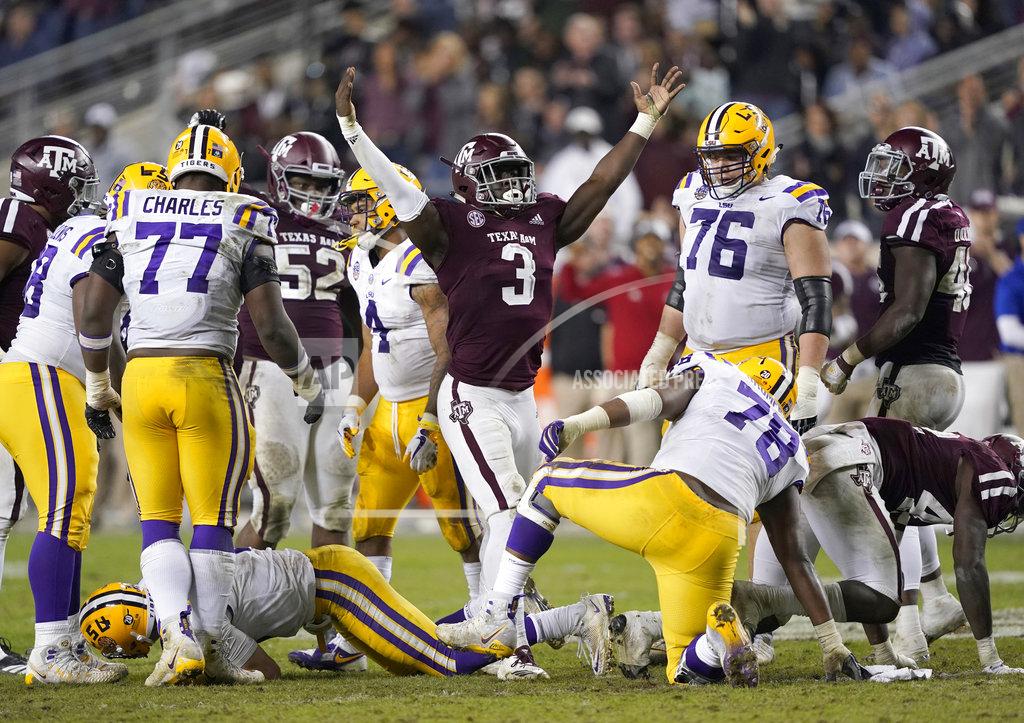 David J. Phillip Texas A&M defensive lineman Tyree Johnson (3) celebrates after sacking LSU quarterback Joe Burrow during the second half of an NCAA college football game Saturday, Nov. 24, 2018, in College Station, Texas. Texas A&M won 74-72 in seven overtimes. (AP Photo/David J. Phillip)
