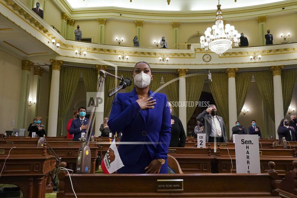 Electoral Tayte William leads members of California's Electoral College in the Pledge of Allegiance at the state Capitol in Sacramento, Calif., Monday, Dec. 14, 2020. Williams was selected by Vice President-elect Sen. Kamala Harris to represent her at the Electoral College. (AP Photo/Rich Pedroncelli, Pool)