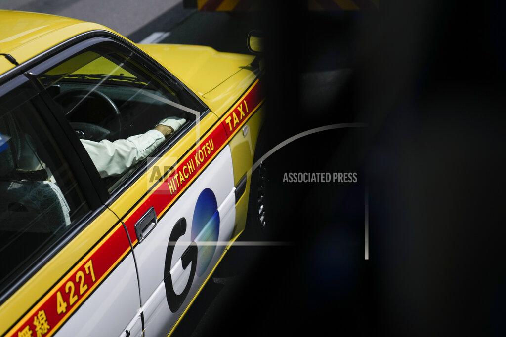 Jae C. Hong A taxi driver wears a white glove ahead of the 2020 Summer Olympics, Tuesday, July 13, 2021, in Tokyo. (AP Photo/Jae C. Hong)