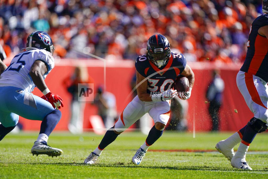Jack Dempsey Denver Broncos running back Phillip Lindsay, center, runs with the ball during the first half of an NFL football game against the Tennessee Titans, Sunday, Oct. 13, 2019, in Denver. (AP Photo/Jack Dempsey)