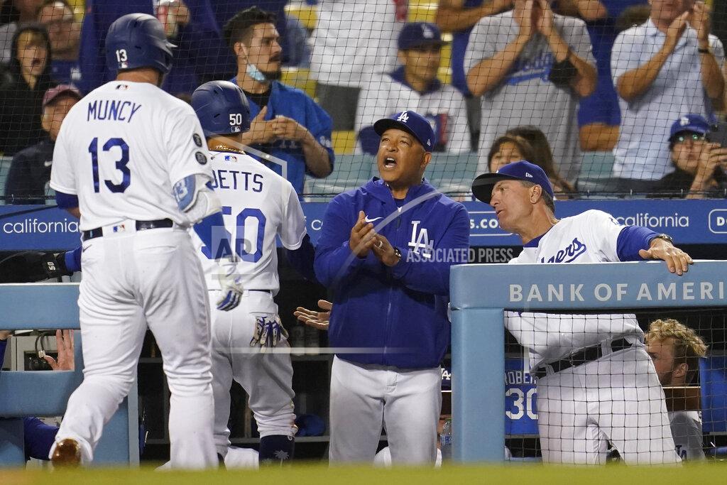 Marcio Jose Sanchez Los Angeles Dodgers' Max Muncy (13) and Mookie Betts are met at the dugout by manager Dave Roberts, center, and bench coach Bob Geren after Muncy's two-run home run during the third inning of the team's baseball game against the Arizona Diamondbacks on Tuesday, Sept. 14, 2021, in Los Angeles. (AP Photo/Marcio Jose Sanchez)